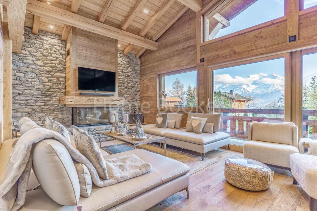 a living room with a stone wall at Chalet Annelya in Combloux