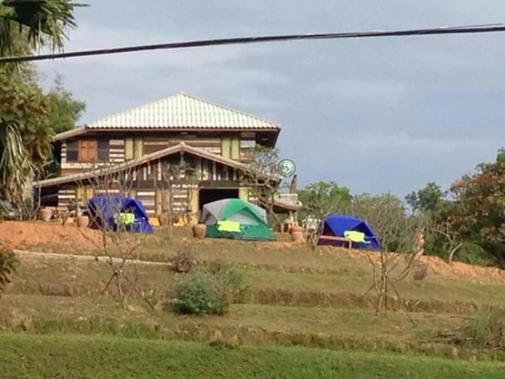 a house with three tents in front of it at Khaokor Remind by Palek in Khao Kho