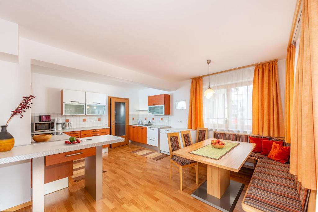 uma cozinha e sala de estar com uma mesa e uma sala de jantar em Appartementhaus Steirergasse by Schladming-Appartements em Schladming