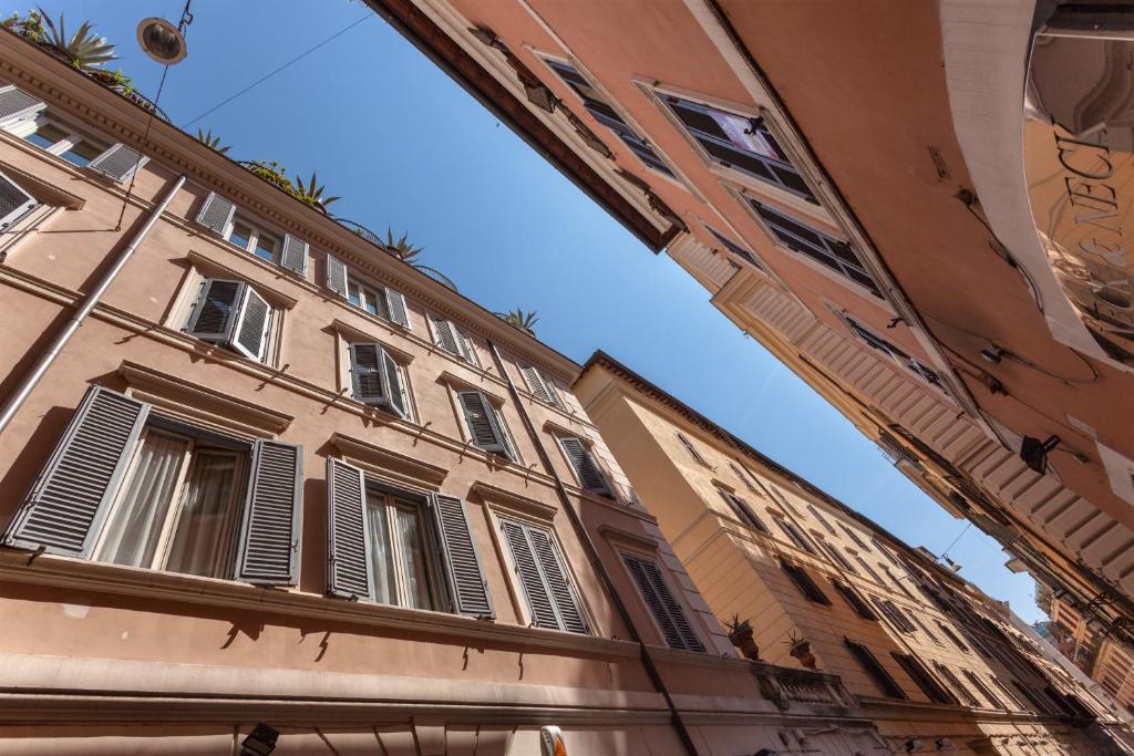 a building with shuttered windows on a street at Vittoria Street Charming in Rome