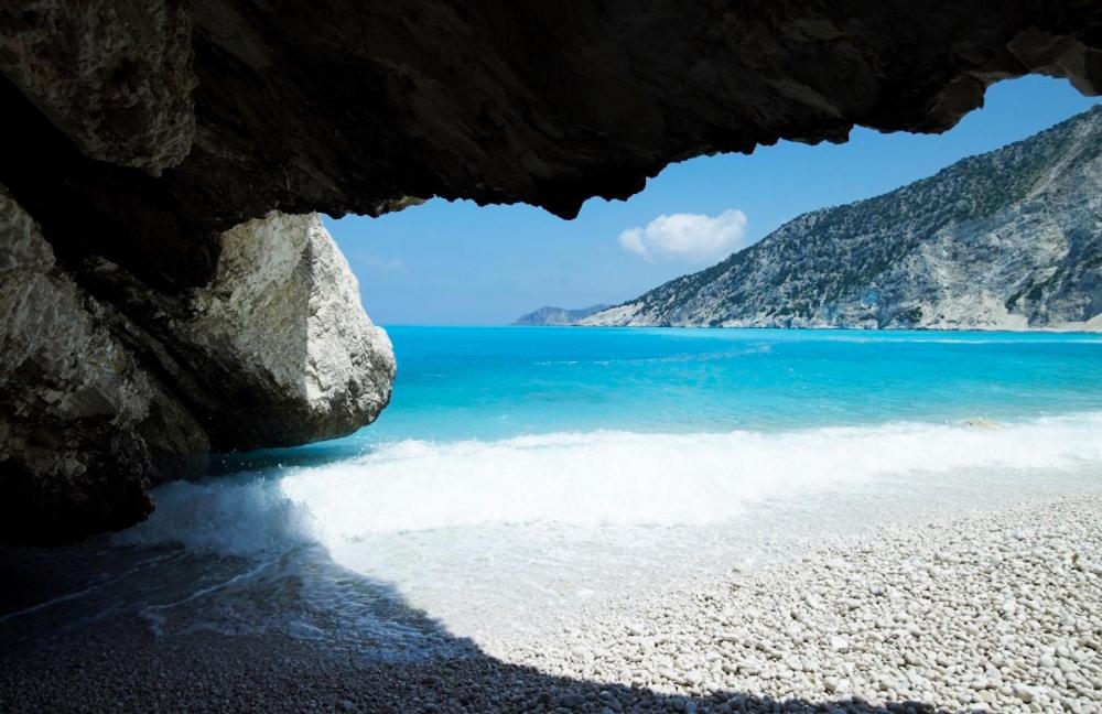a view of a beach from inside a cave at Muses Studios Sami in Sami