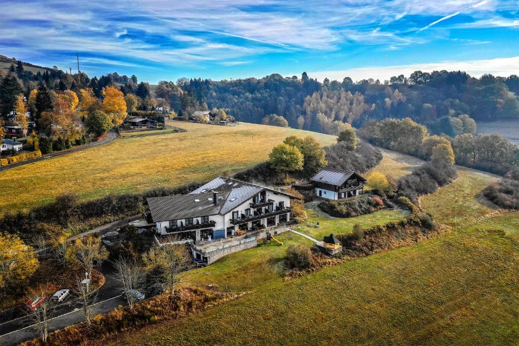 an aerial view of a large house on a hill at Landhaus Müllenborn in Gerolstein