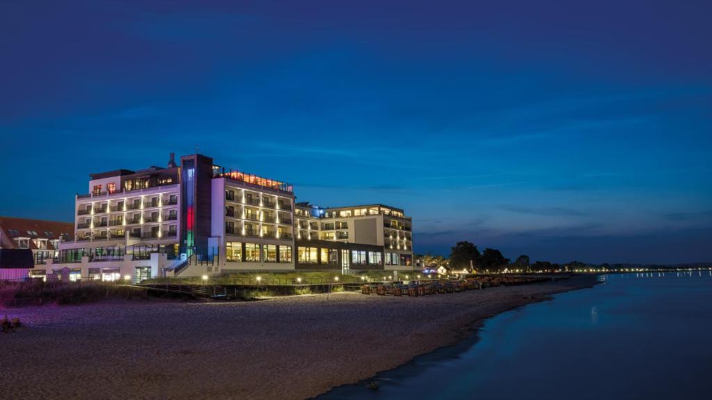 a building sitting on the beach at night at Bayside in Scharbeutz