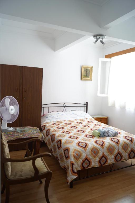 a bedroom with a bed and a chair and a lamp at ★ Plaka, Center of all Greek Legends ★ in Athens