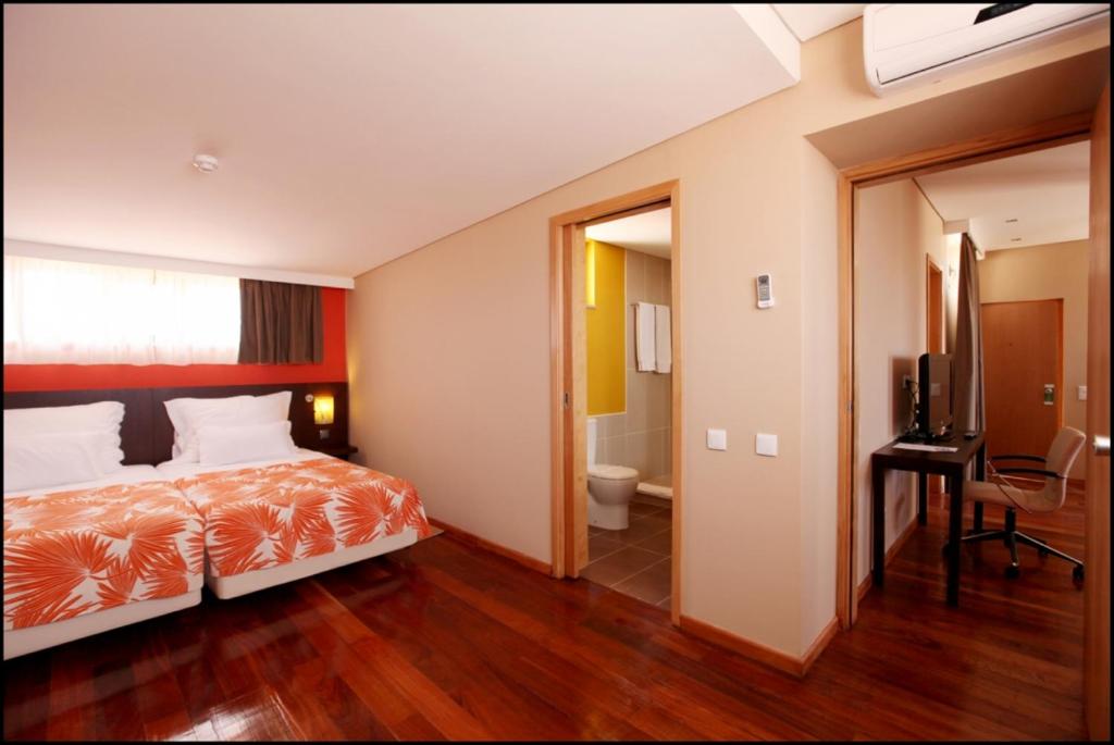 Postel nebo postele na pokoji v ubytování Pestana Tropico Ocean & City Hotel
