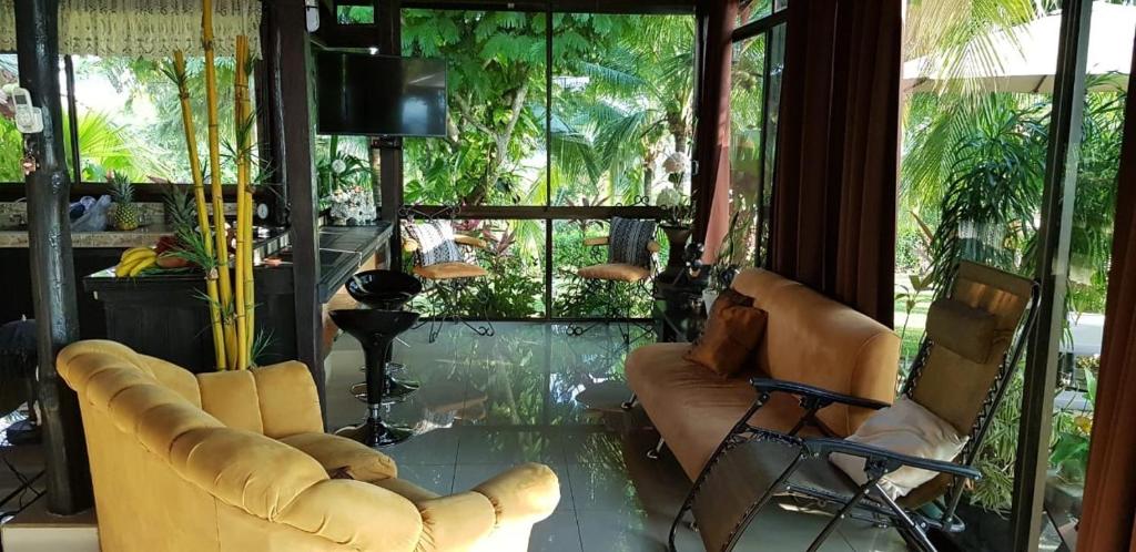 a living room with two chairs and a glass floor at Villa Guarias in Puntarenas