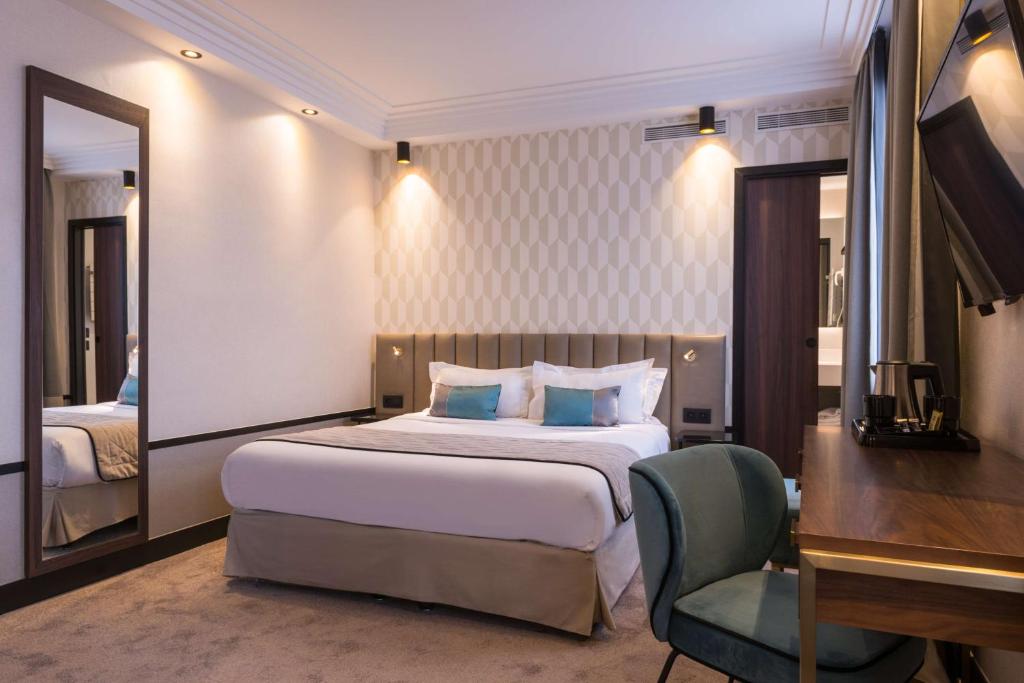 a bedroom with a bed and a desk and a mirror at Best Western Select Hotel in Boulogne-Billancourt