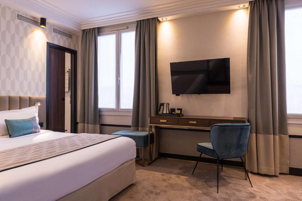 a hotel room with a bed and a desk and a television at Best Western Select Hotel in Boulogne-Billancourt