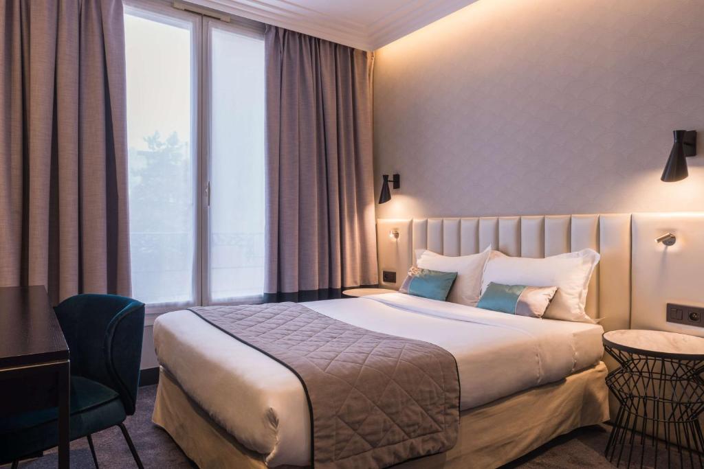 a hotel room with a bed and a large window at Best Western Select Hotel in Boulogne-Billancourt