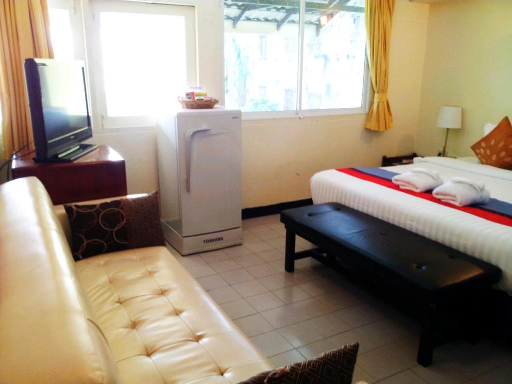 Postel nebo postele na pokoji v ubytování Sawasdee Sukhumvit Inn