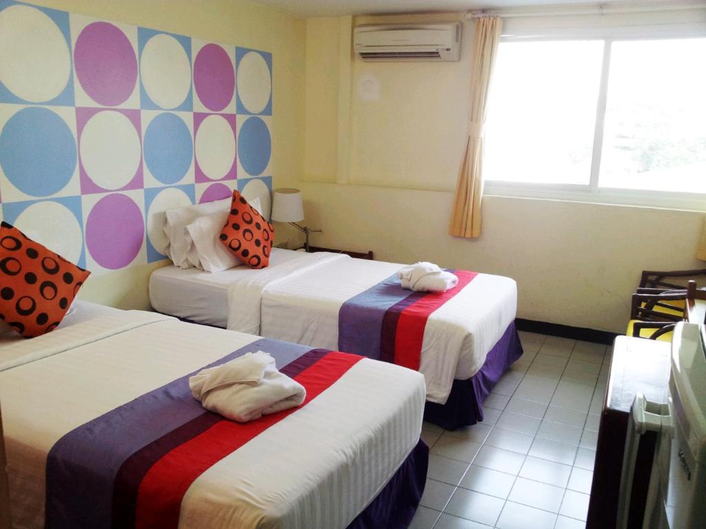 Postel nebo postele na pokoji v ubytování Sawasdee Sukhumvit Inn