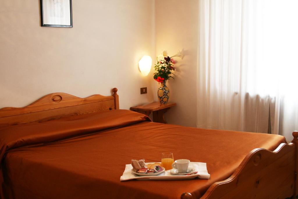 Postel nebo postele na pokoji v ubytování Hotel Residence Turium