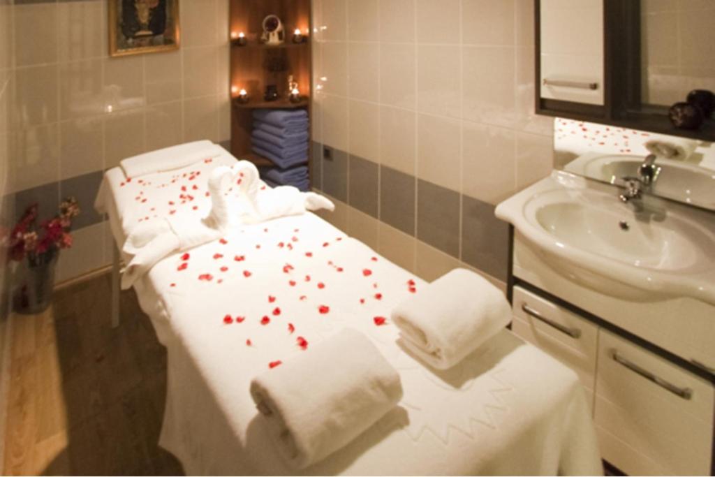 a bathroom with a bed with red hearts on it at Marlight Boutique Hotel in İzmir