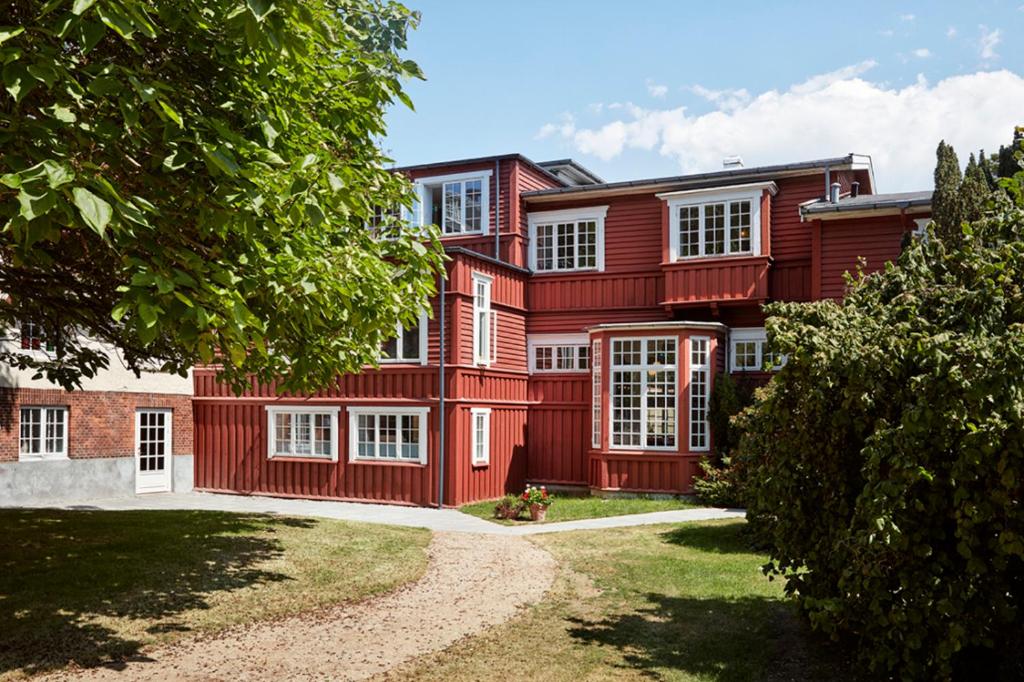 a large red house with white windows at Hotel Hornbækhus in Hornbæk