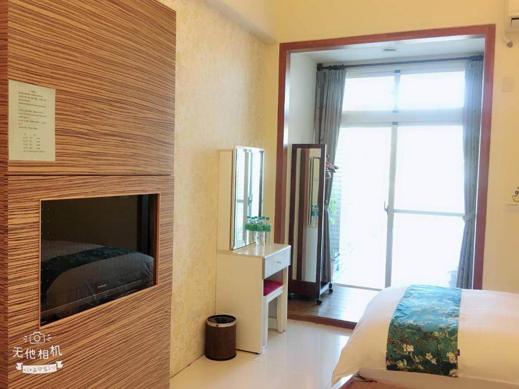 a bedroom with a fireplace and a bed in it at Fish Fun House in Hualien City