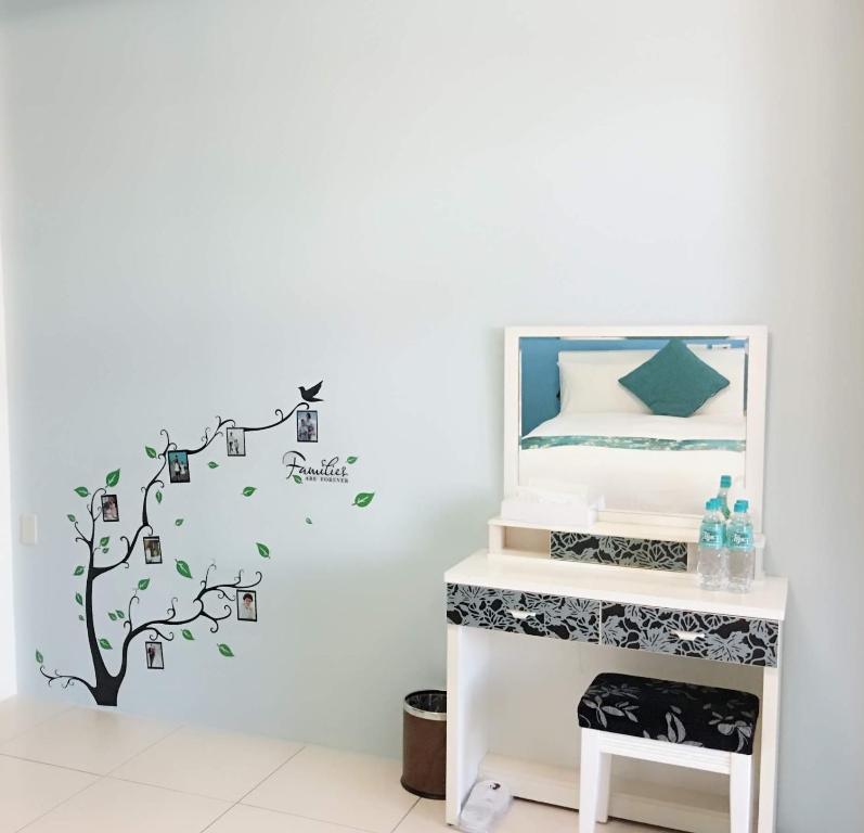 a bedroom with a white wall with a tree with music notes at Fish Fun House in Hualien City