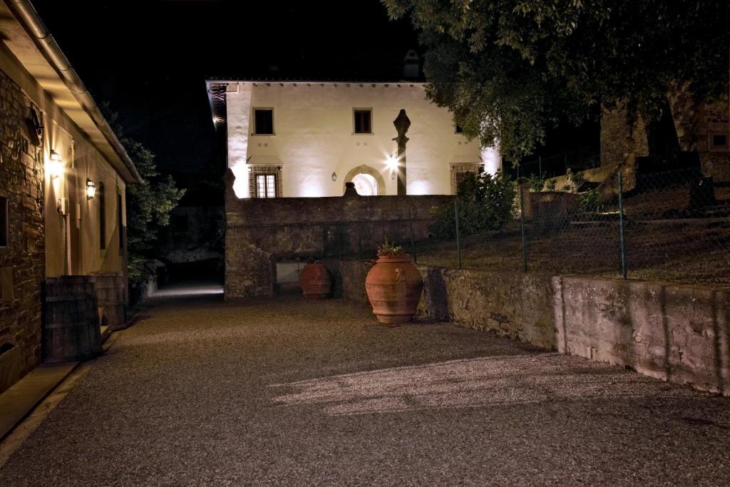 a large vase sitting in front of a building at night at Agriturismo Colognole in Pontassieve