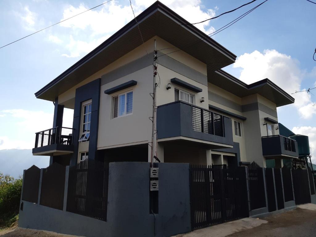 a house with a fence in front of it at Restful 3BR Hillside Duplex House in Baguio