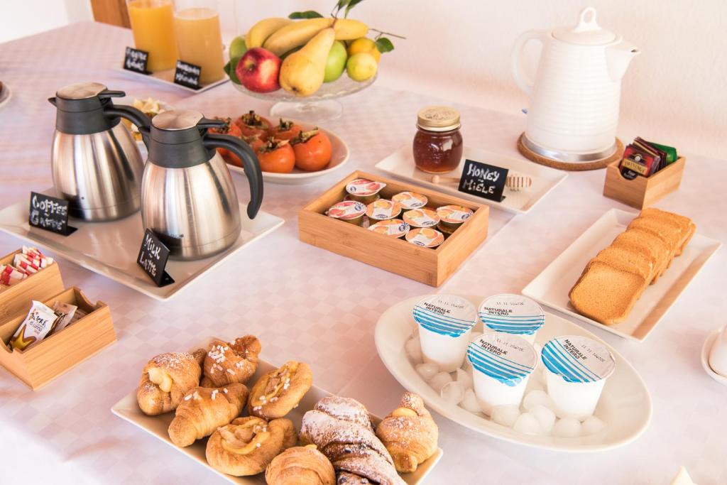 a table topped with different types of pastries and desserts at Il Giardino di Venere in Mondello