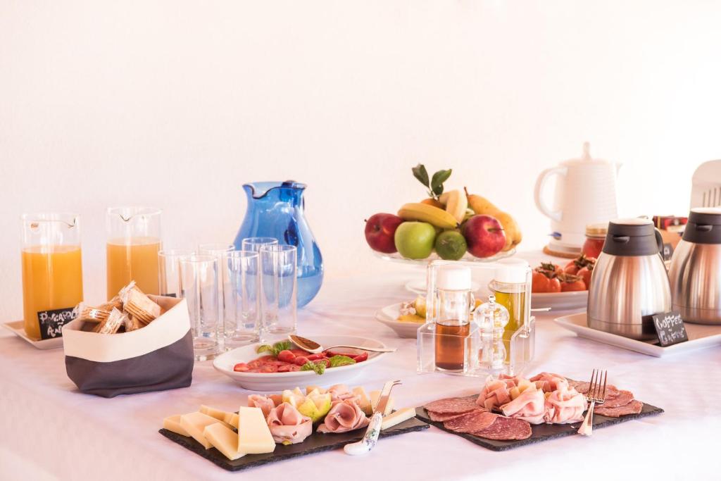 a table with a buffet of food and drinks at Il Giardino di Venere in Mondello