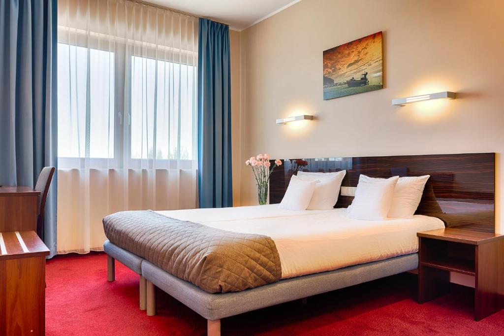 מיטה או מיטות בחדר ב-Focus Hotel Gdańsk