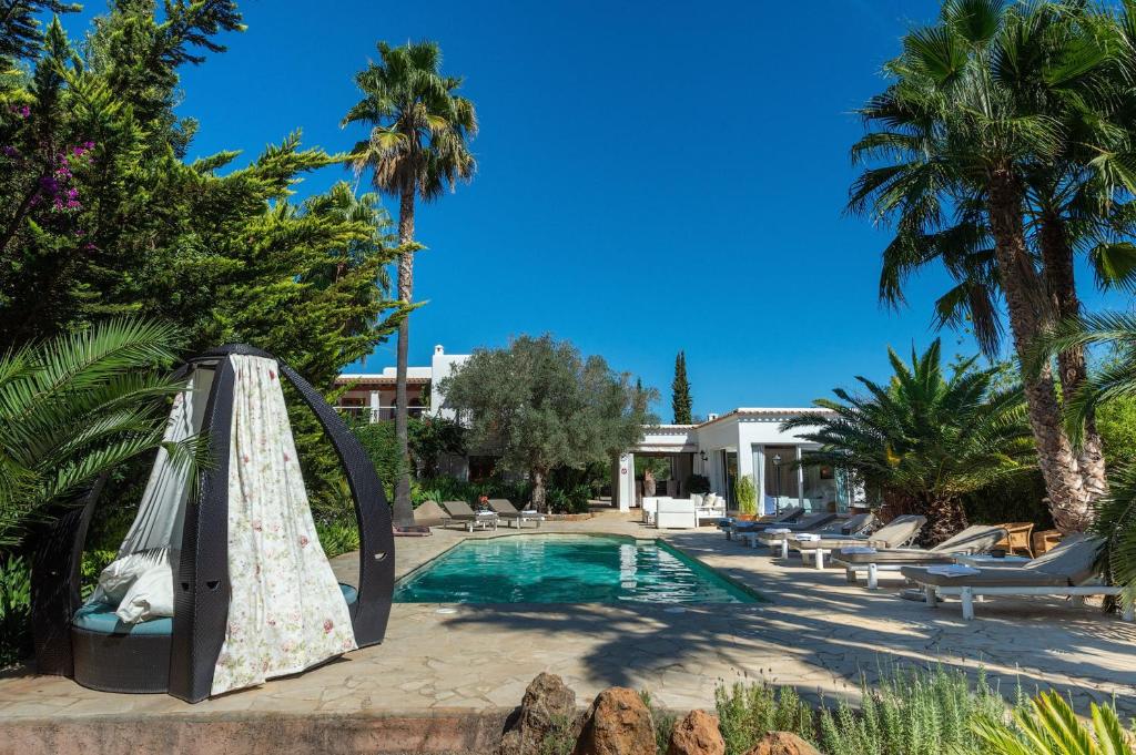 a swimming pool with a swing and a pool at New! Villa Can Colomaret Carmen in Santa Eularia des Riu