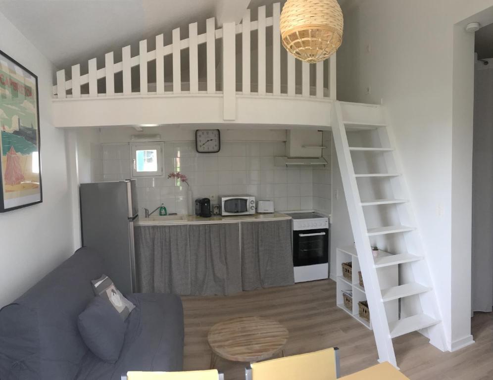 a kitchen and a living room with a loft at Appartement les Elfes in Capbreton