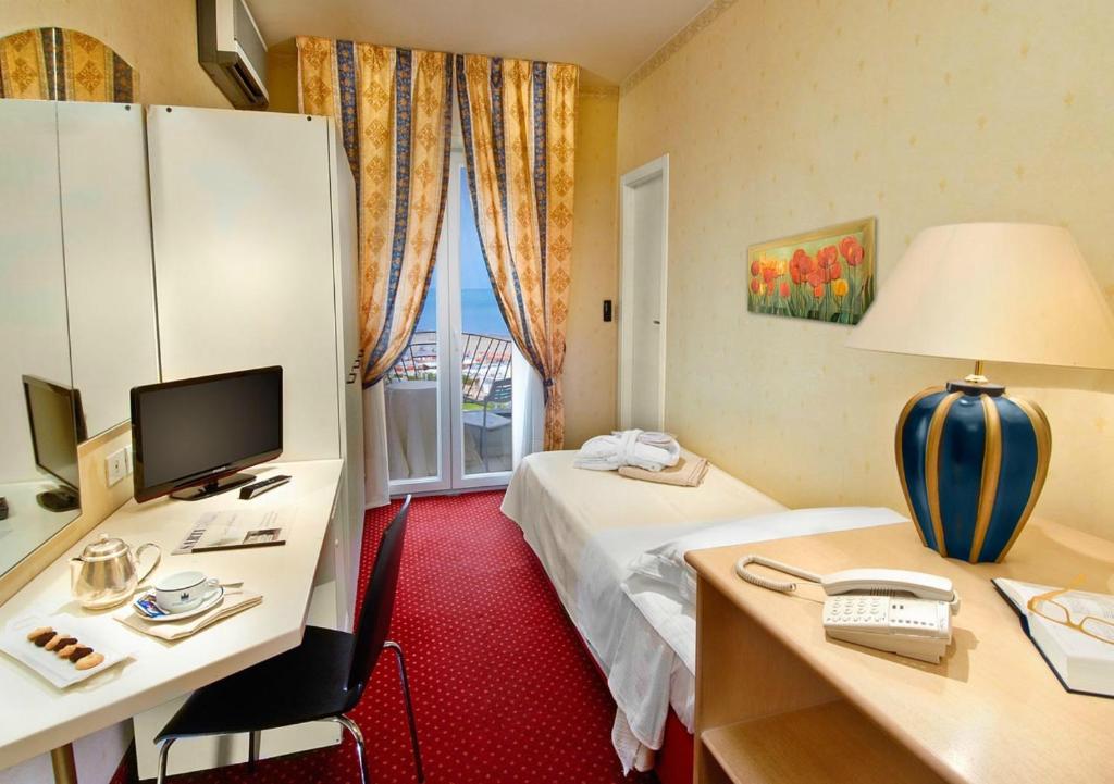 Postel nebo postele na pokoji v ubytování Hotel Sarti
