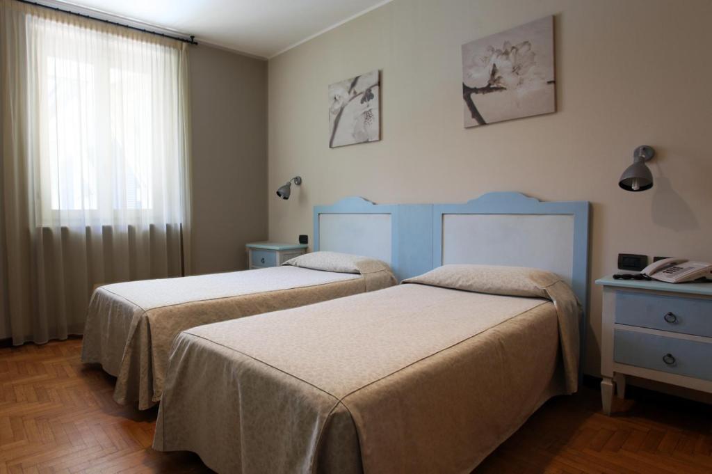 Postel nebo postele na pokoji v ubytování Hotel Risi