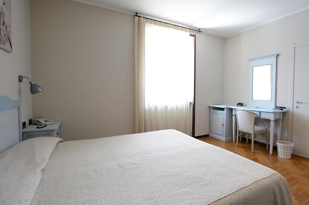 Postel nebo postele na pokoji v ubytování Hotel Risi