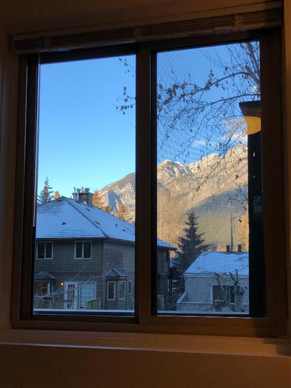 a window with a view of a snow covered mountain at Mountain View Bed & Breakfast in Banff