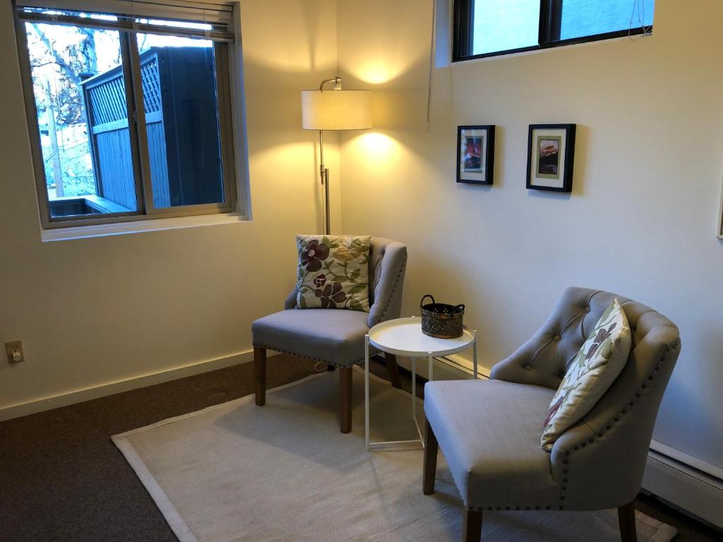 a room with two chairs and a table and a lamp at Mountain View Bed & Breakfast in Banff