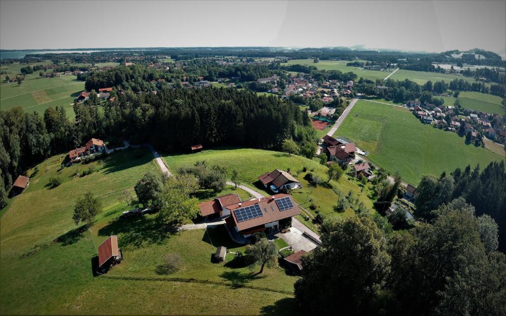 an aerial view of a house on a green field at Ferienwohnung Fritzenwenger in Übersee