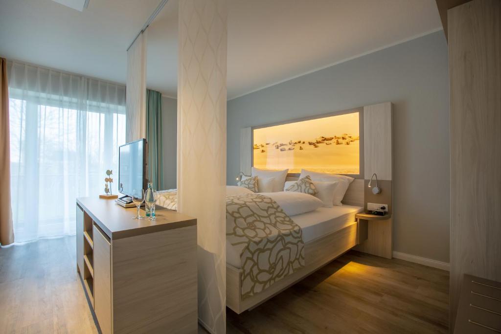 Postel nebo postele na pokoji v ubytování Nordsee Lodge