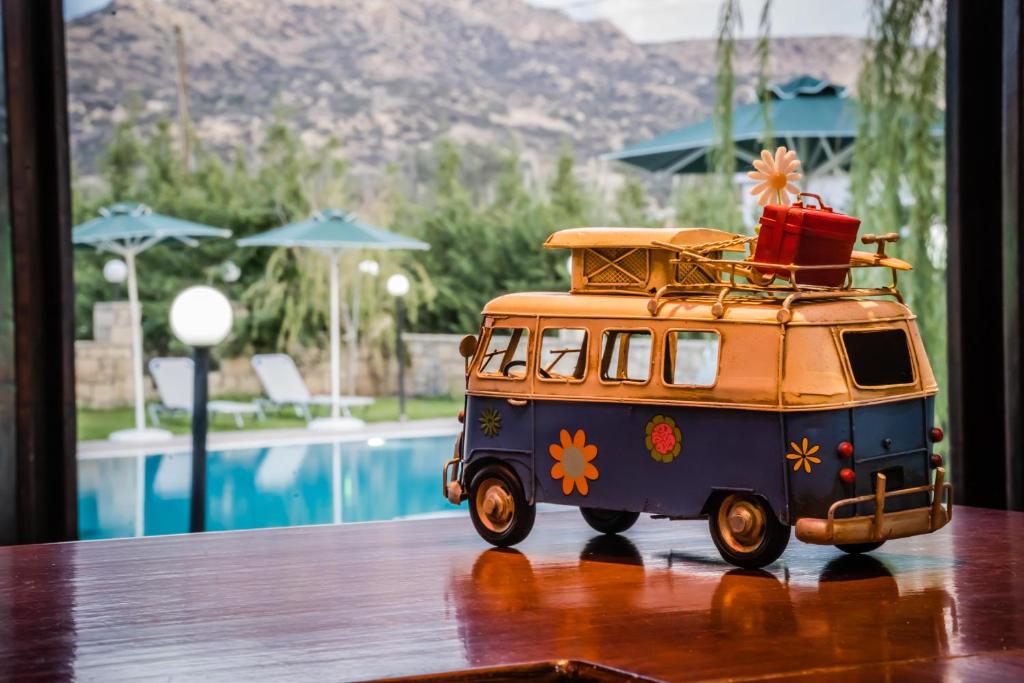a toy van on a table next to a pool at Dimitris Villa Hotel in Matala