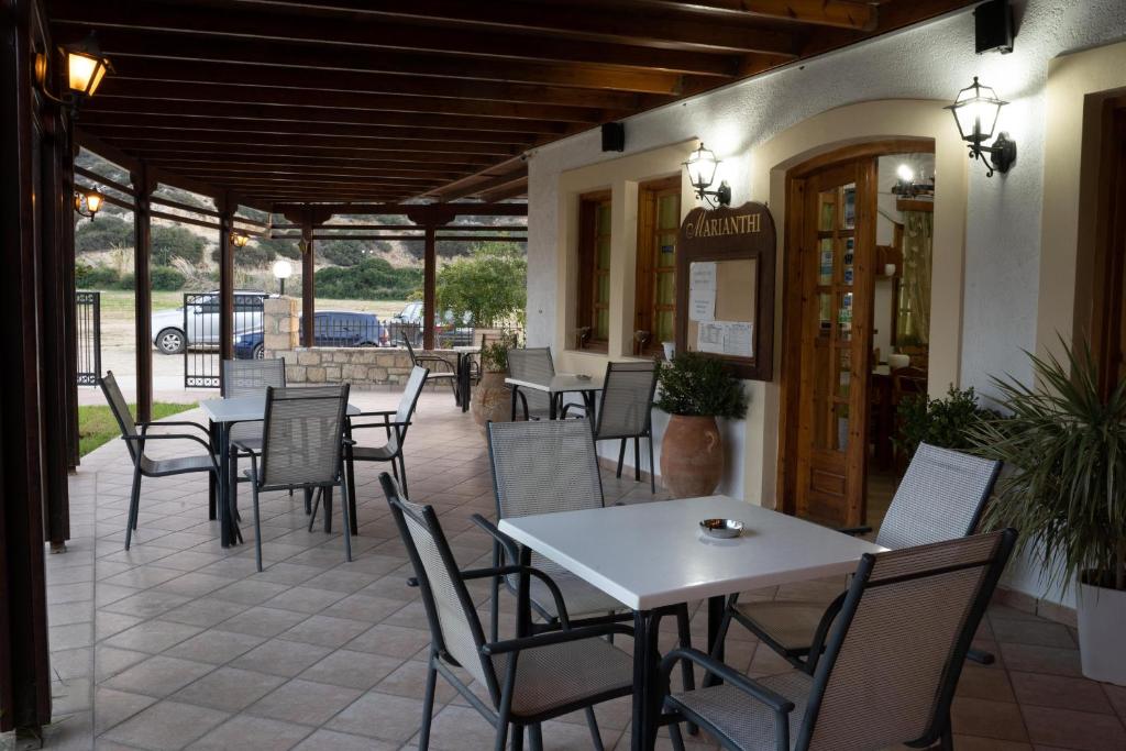 a patio with tables and chairs in a restaurant at Dimitris Villa Hotel in Matala