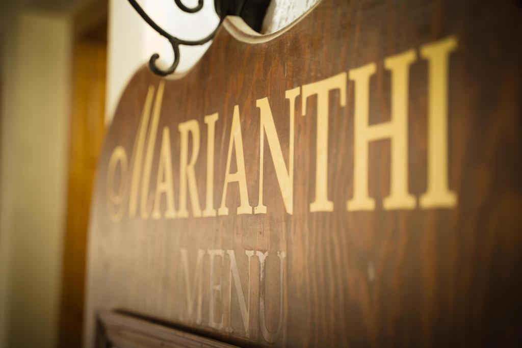 a wooden sign with the name of a pharmacy on it at Dimitris Villa Hotel in Matala
