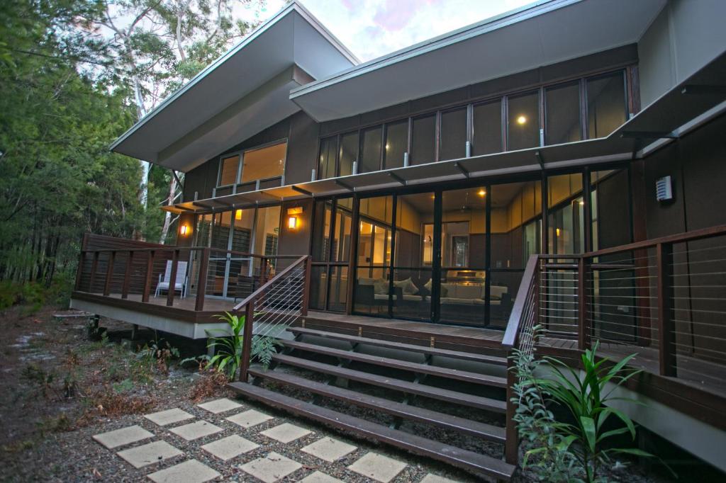 a house with a staircase leading to it at The Sanctuary in Noosa North Shore