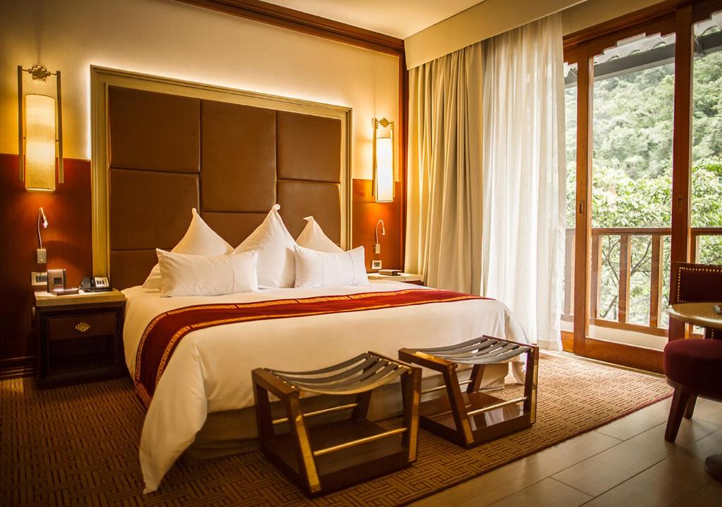 Postel nebo postele na pokoji v ubytování Sumaq Machu Picchu Hotel