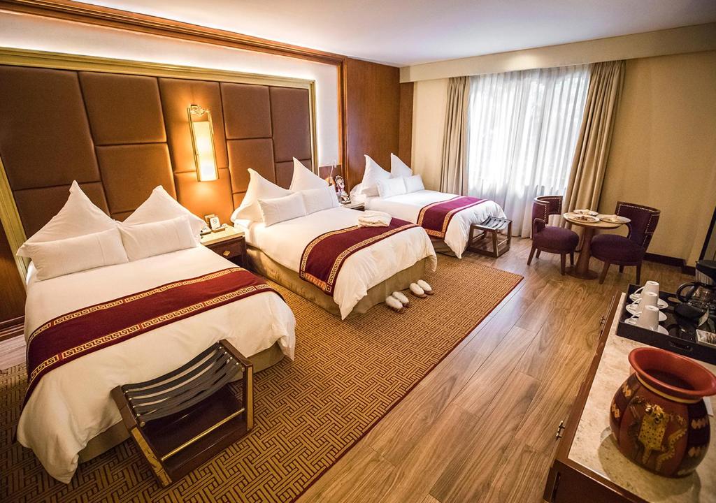 Postel nebo postele na pokoji v ubytování Sumaq Machu Picchu Hotel