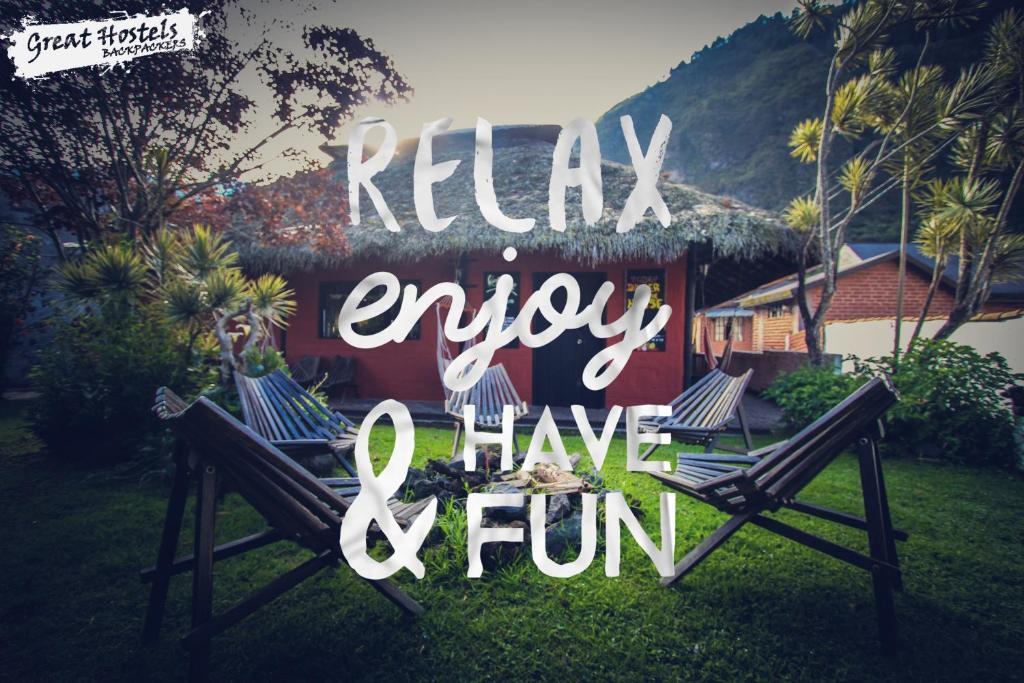 a sign that says relax enjoy and have fun at Great Hostels in Baños