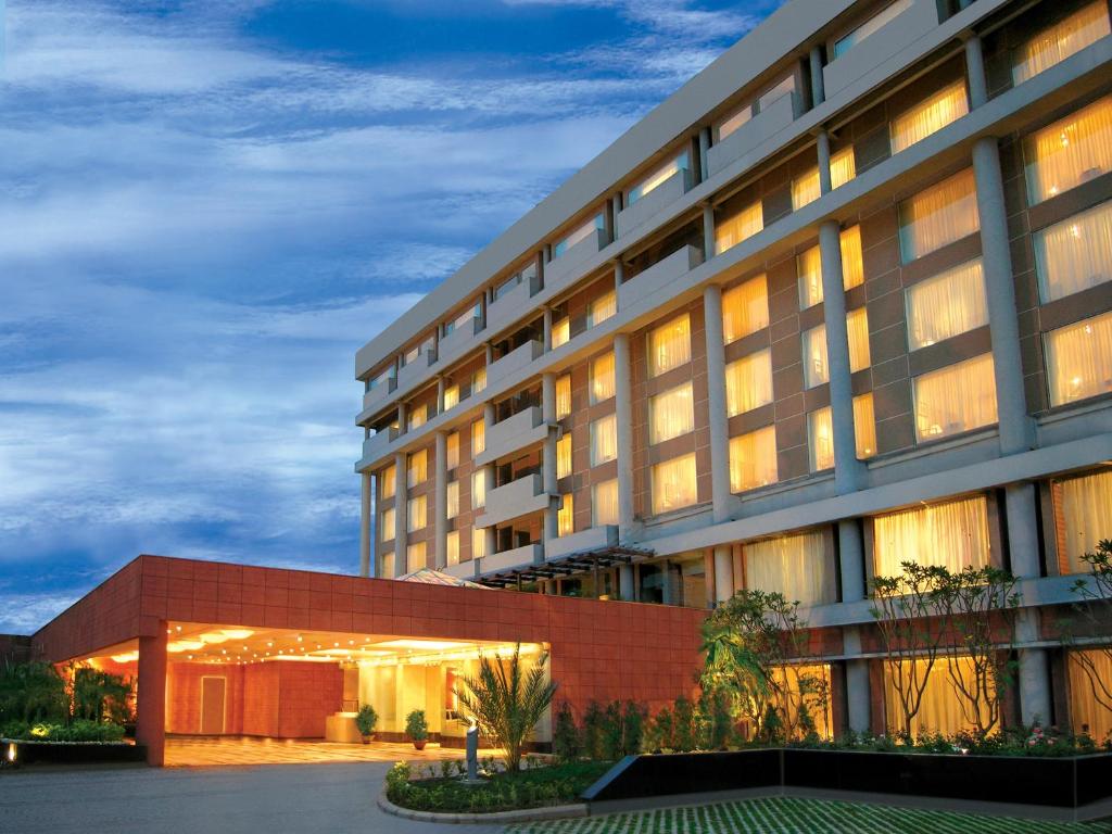 a large building with a lit up facade at night at Taj Chandigarh in Chandīgarh