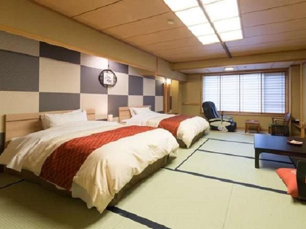 Postel nebo postele na pokoji v ubytování Hotel Oyanagi