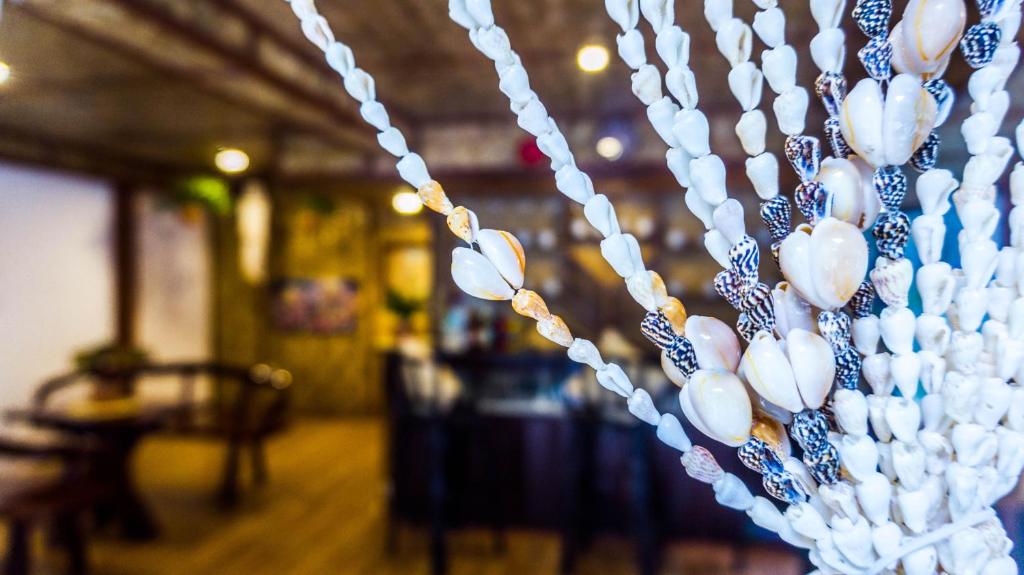 a string of white pearl beads hanging in a room at Ced Pension in El Nido