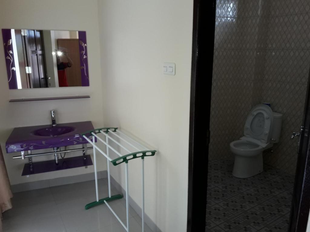 uma casa de banho com um lavatório e um WC em Toraja Lodge Hotel em Rantepao