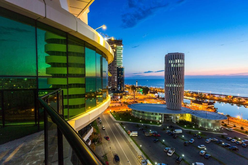 a view of a city at night from a building at Best Western Premier Batumi in Batumi