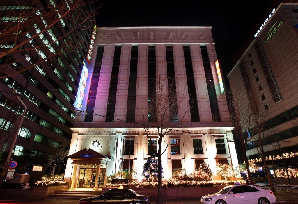 a tall building with christmas lights on it at Karak Tourist Hotel in Seoul