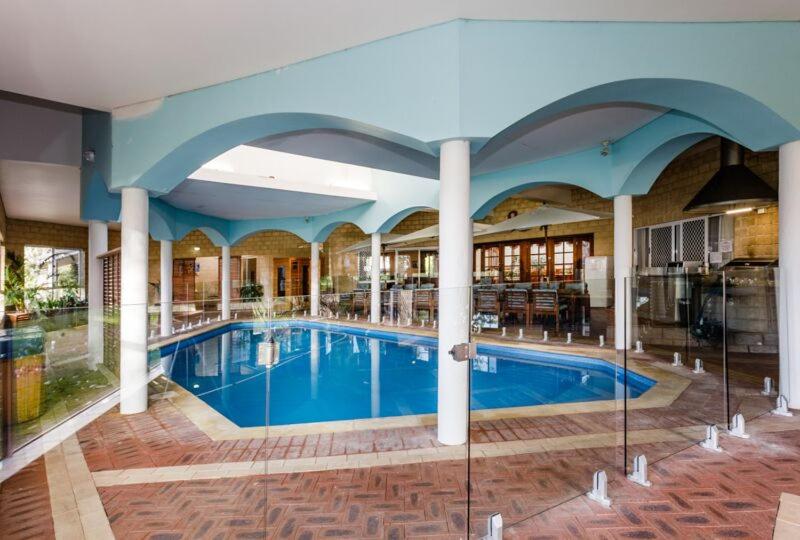 a large swimming pool in a large building at Inn The Tuarts Guest Lodge Busselton Accommodation - Adults Only in Busselton