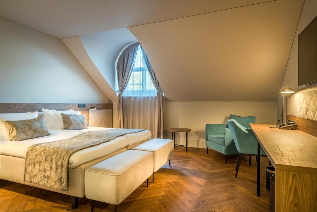 Postel nebo postele na pokoji v ubytování Hotel Vilnia