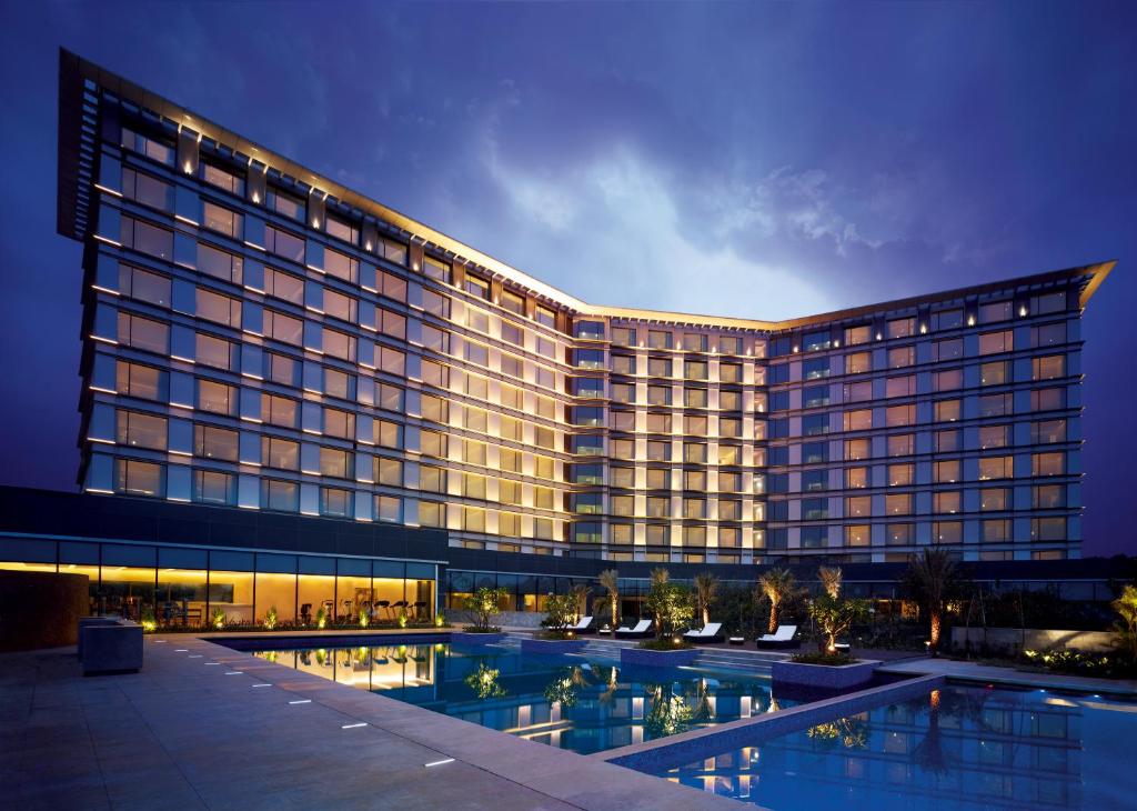 ein großes Gebäude mit Pool davor in der Unterkunft Taj Yeshwantpur Bengaluru in Bangalore